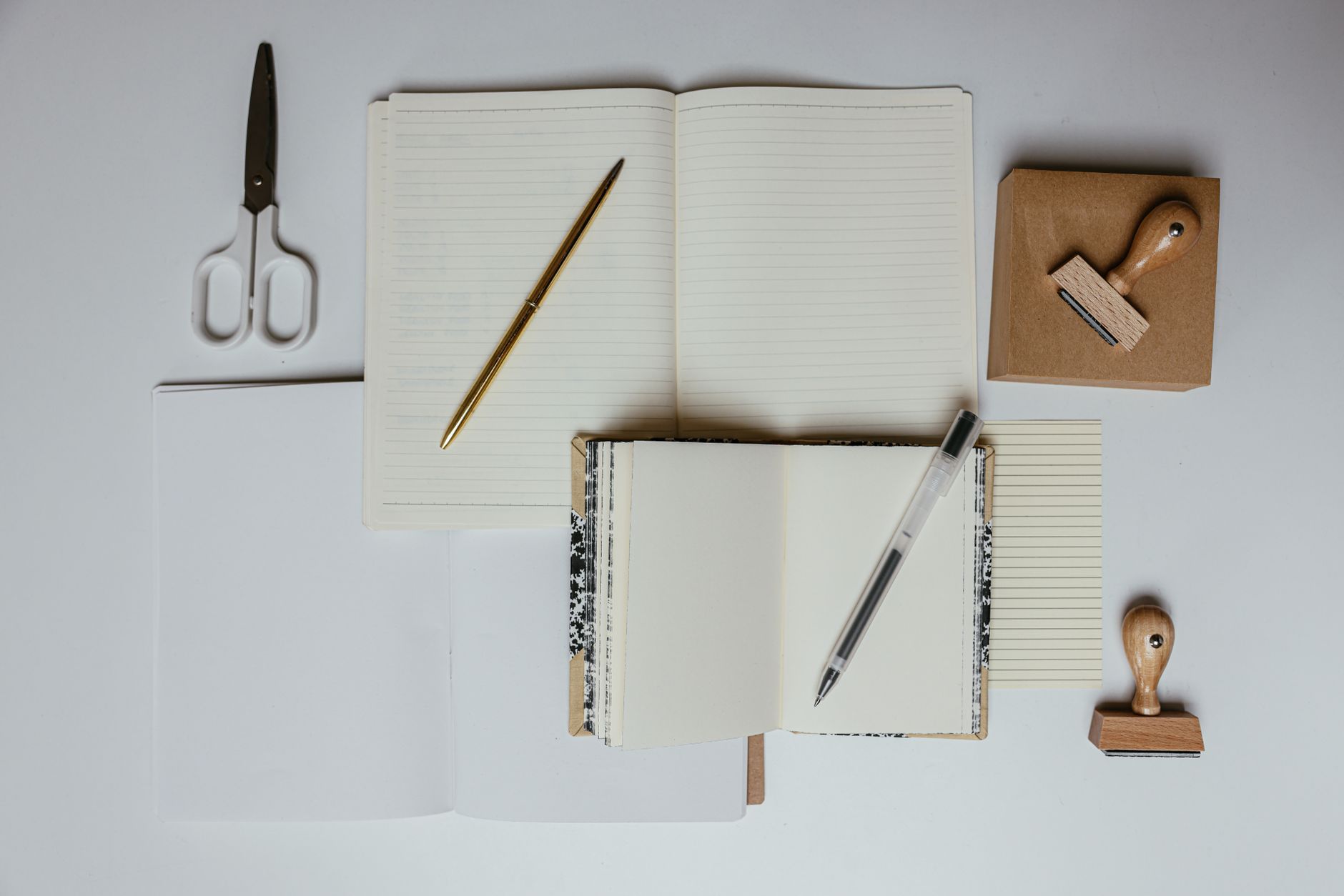 Flat lay of printed brand stationery, cards and swatches on a desk